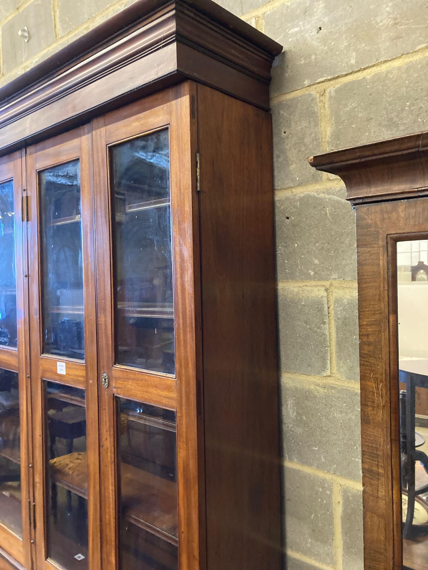 A Victorian mahogany bookcase cupboard, with pull out mid section writing slide, width 144cm depth 50cm height 245cm